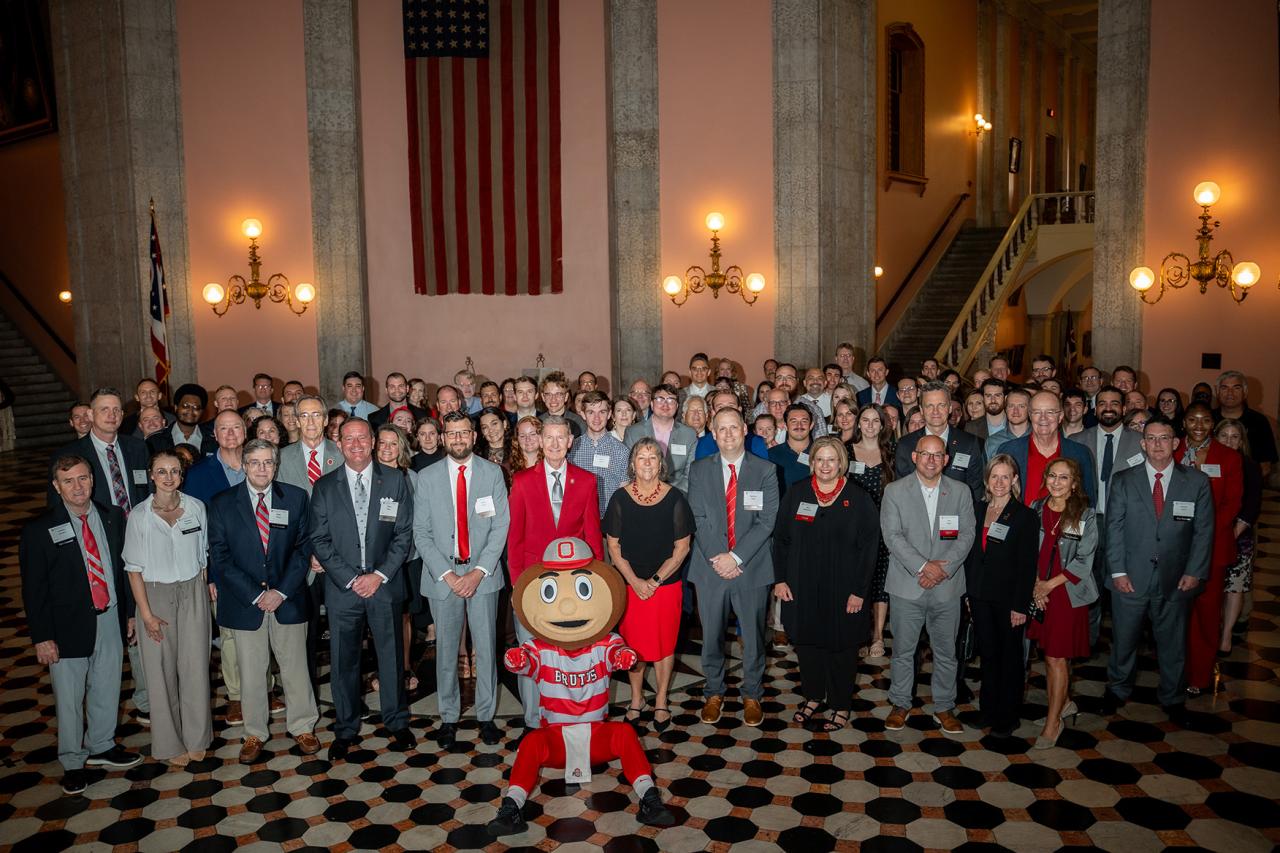 Large group of event goers smiling with Brutus